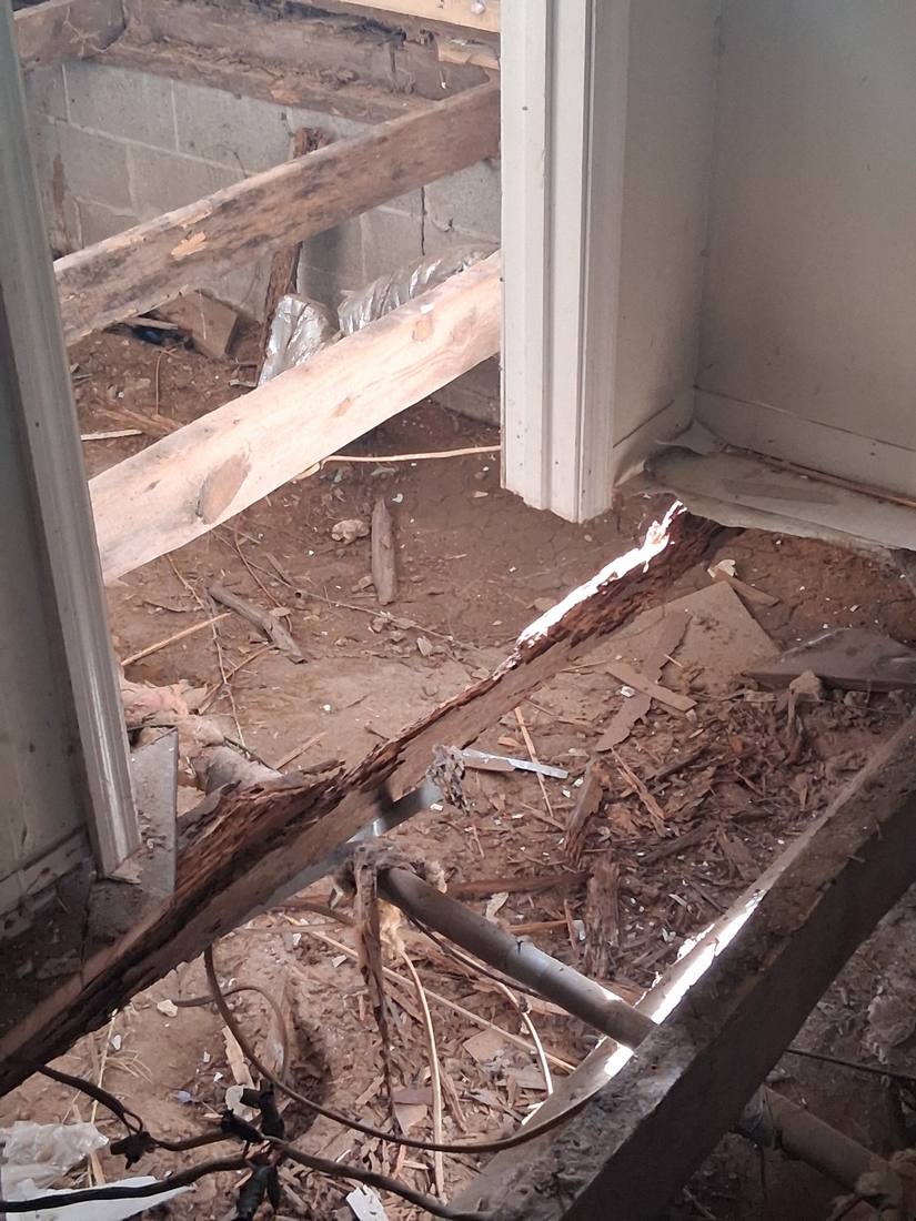 Rotted floor joists and subfloor exposed during a demolition project in Campbell County, TN