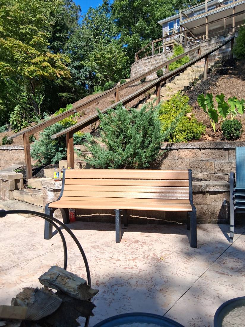 Finished stone patio with bench built by Lemarr Excavating & Landscaping in Campbell County, TN