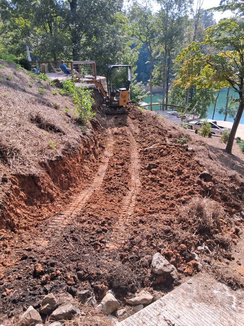 Excavated hillside trench cut for a retaining wall footing in Campbell County, TN